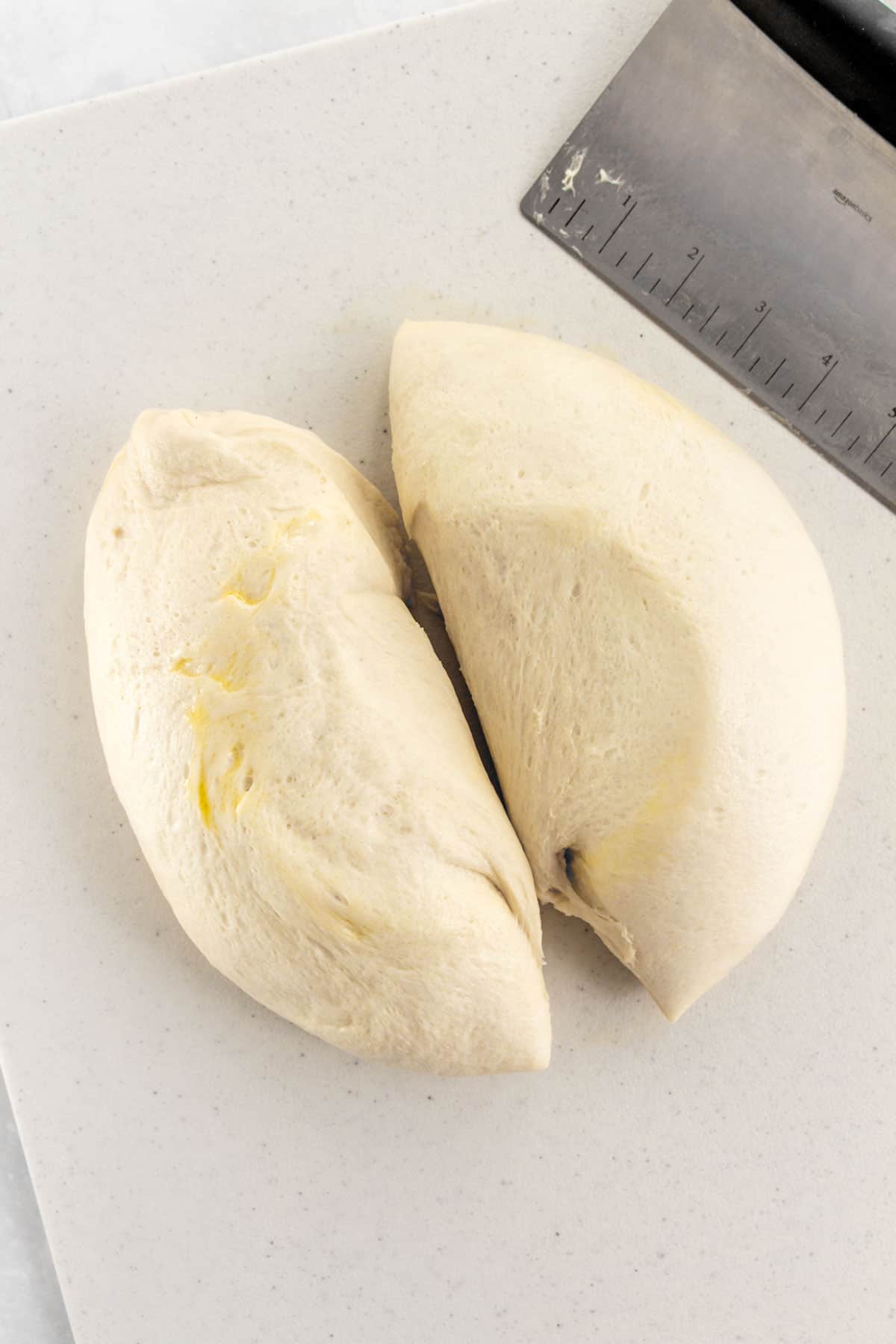 Scallion bread dough split in half.