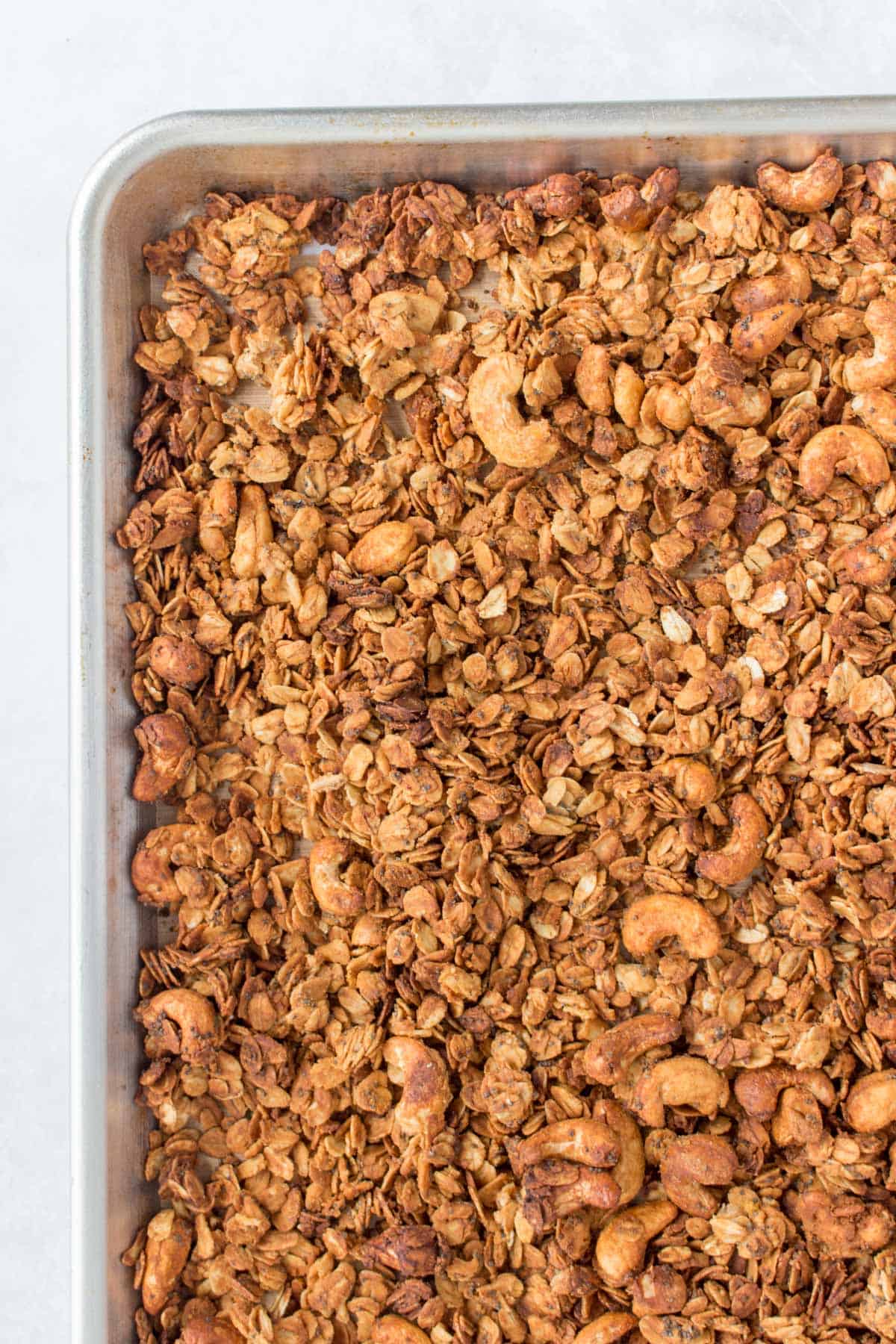 Close up of granola on a sheet pan.