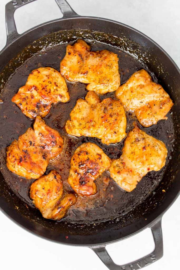 Chicken thighs coated with hot honey sauce.