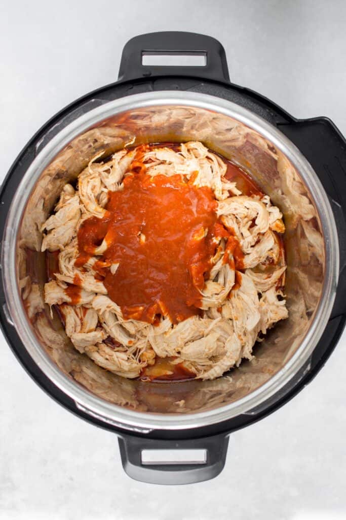 More buffalo sauce added to the shredded chicken.