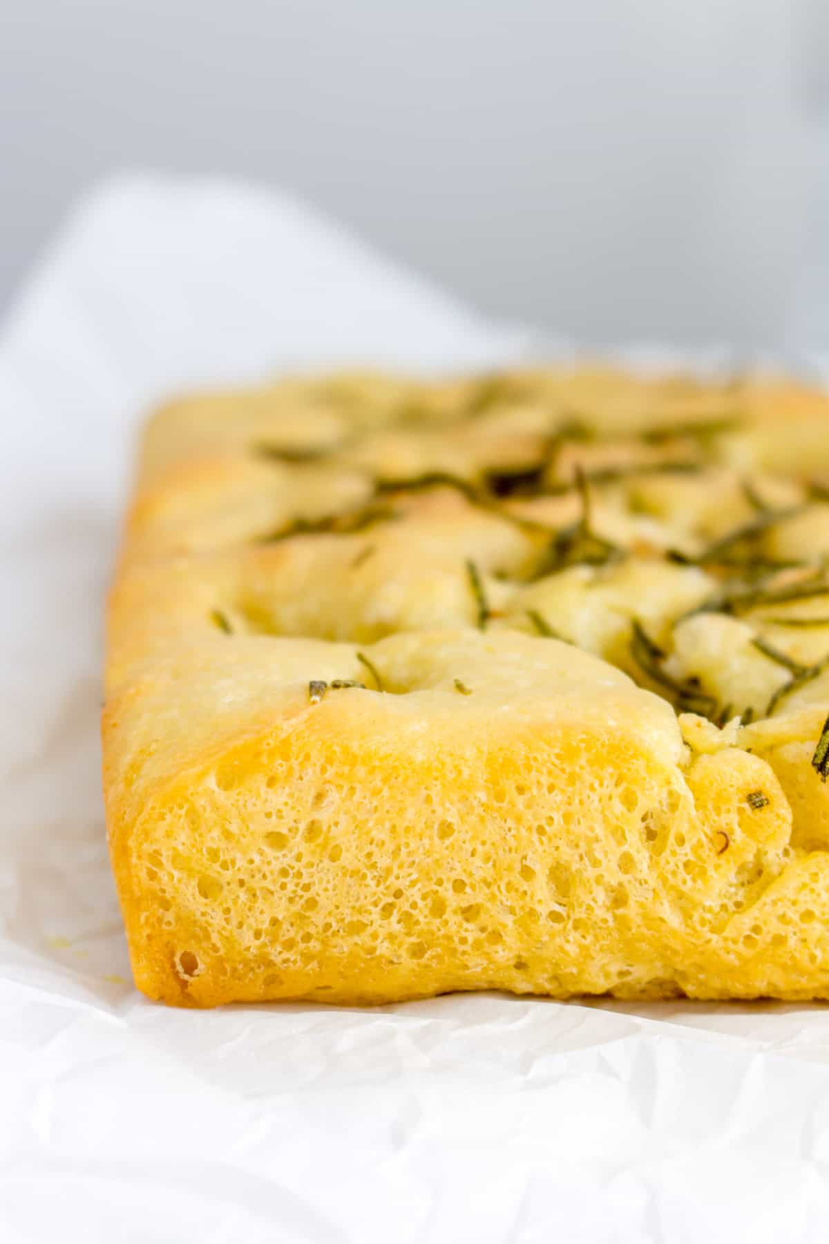 Close up of the crust of a rosemary and garlic focaccia.