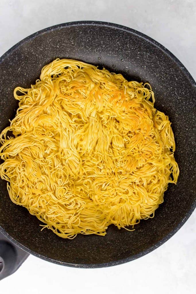 Crispy pan fried noodles in a pan.