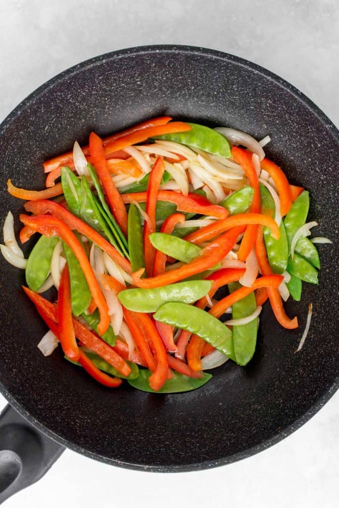 Onions, snow peas, and bell peppers stir fried.