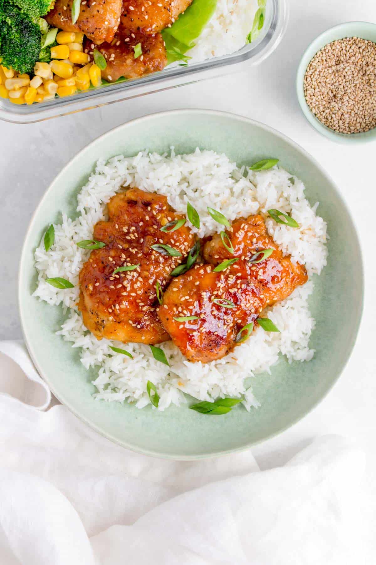 Plate of rice with sriracha honey garlic chicken thighs.