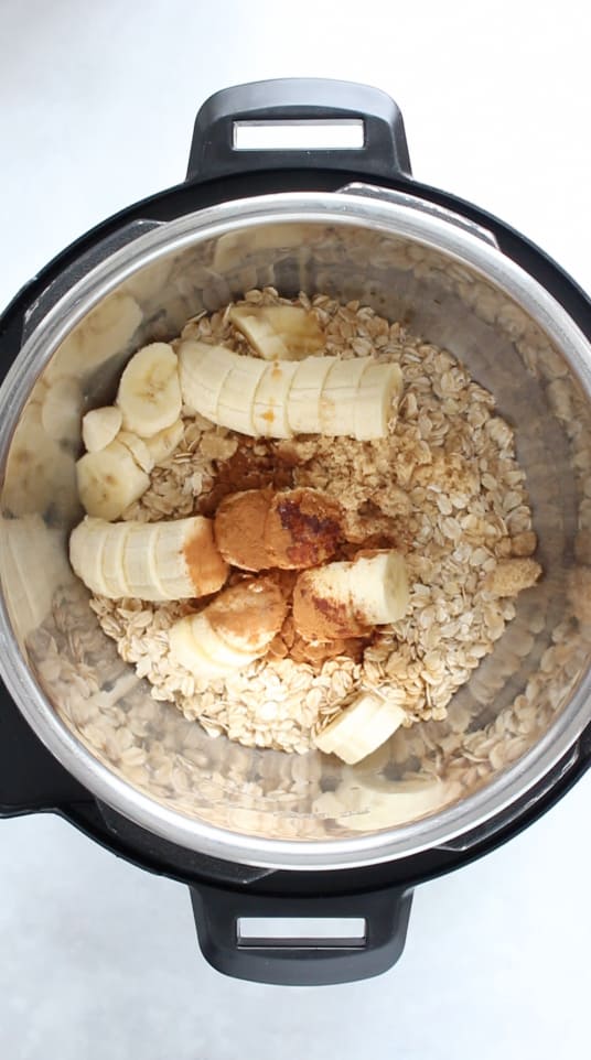 Instant pot with ingredients for oatmeal ingredients inside.