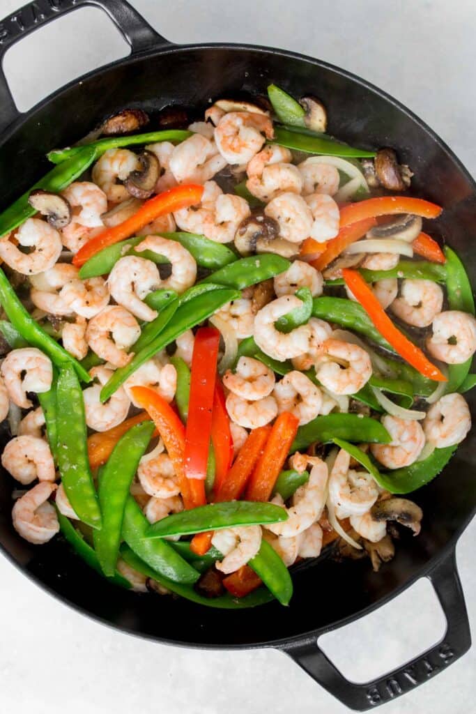 Cooked stir fry shrimp with vegetables in a pan.