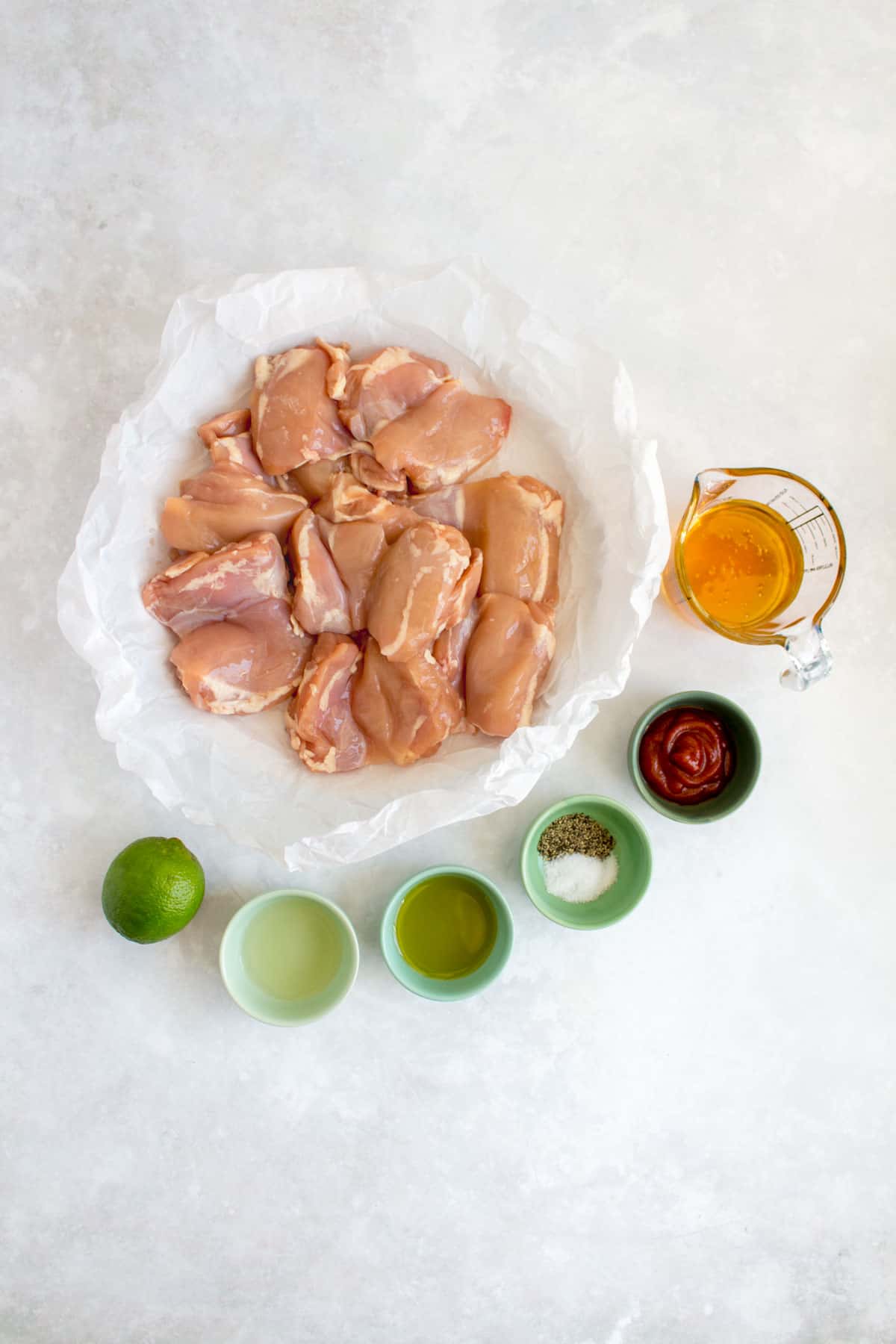 Ingredients needed to make honey sriracha lime chicken thighs.