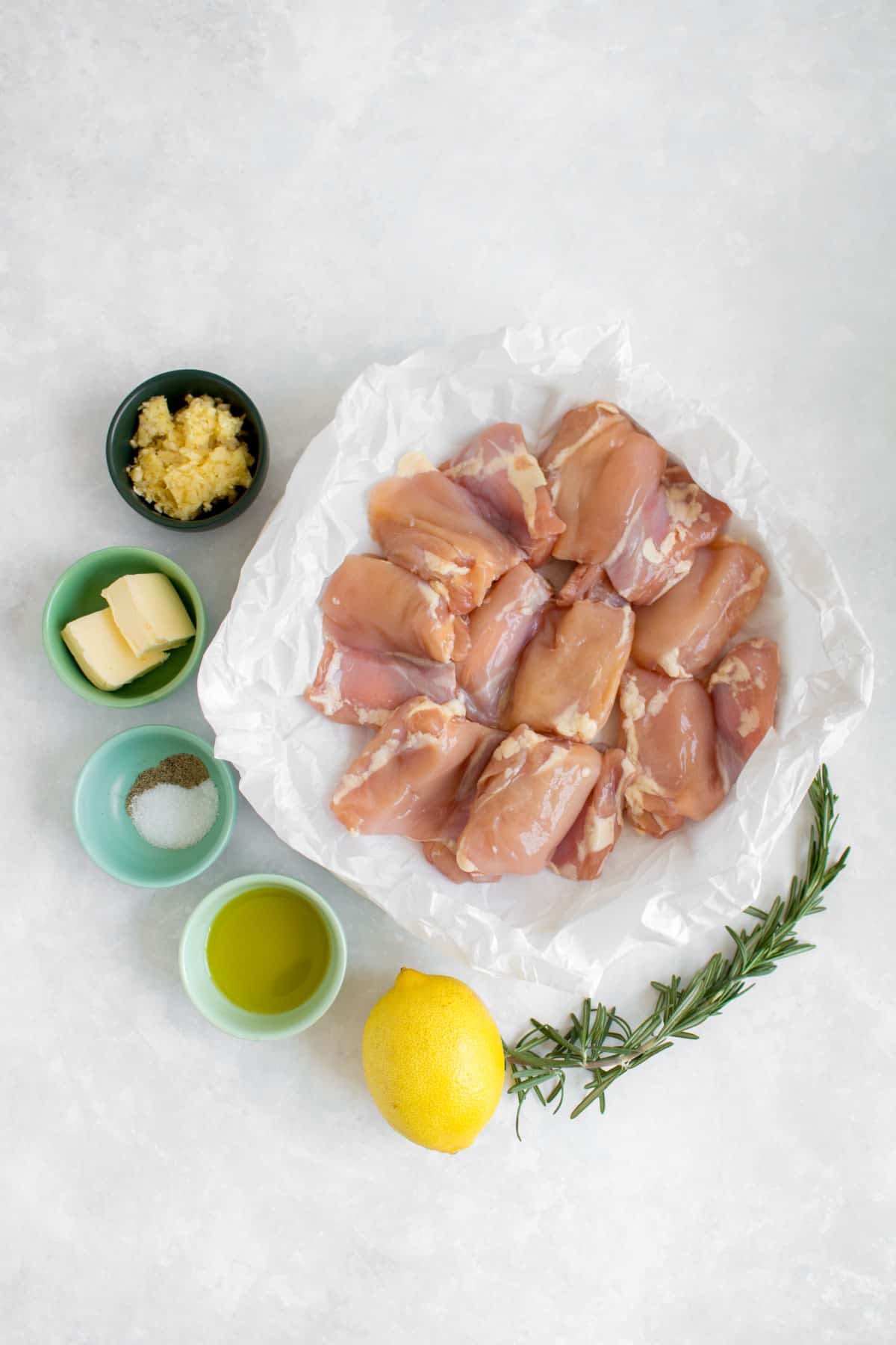 Ingredients needed to make lemon rosemary chicken thighs with garlic butter.