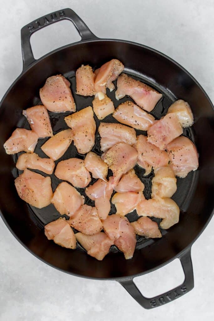 Chicken cubes in a Staub pan.