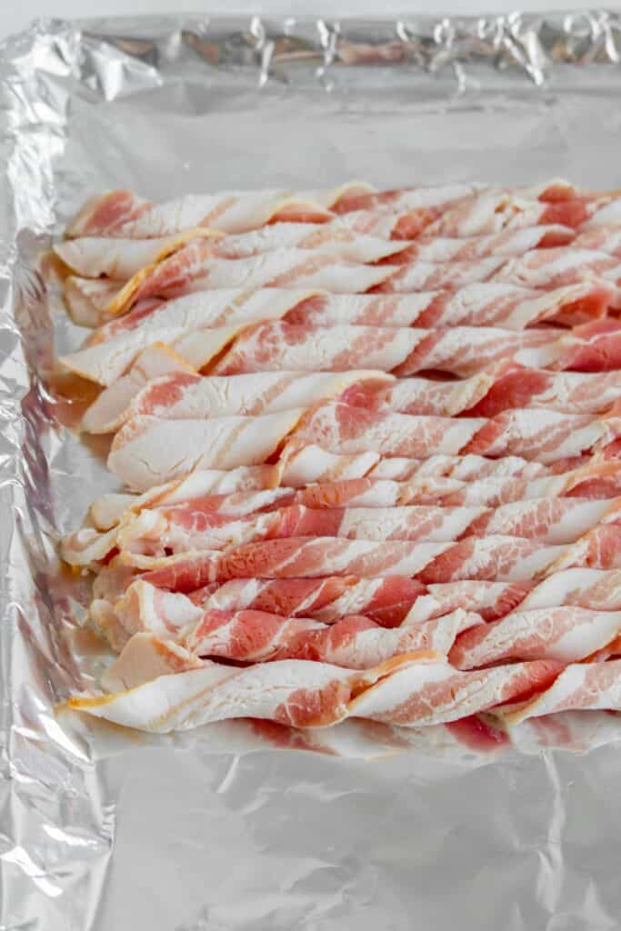 Twisted bacon on a sheet pan before baking.
