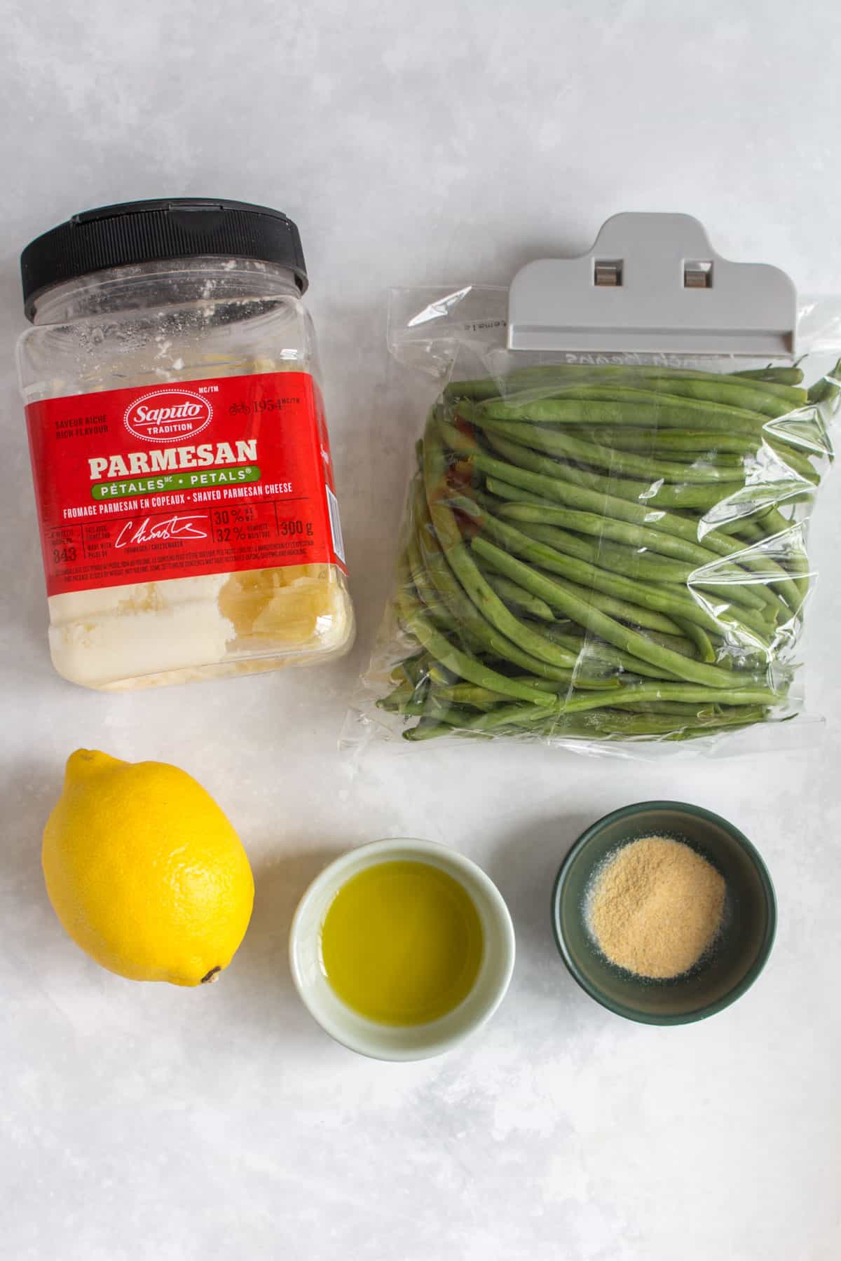 Ingredients needed to make air fryer green beans with garlic, lemon, and parmesan.