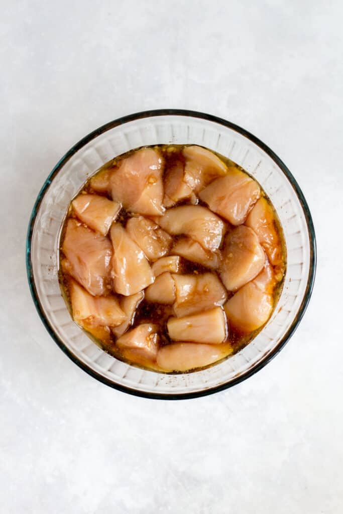 Chicken breasts cut into cubes, marinating in honey garlic sauce.