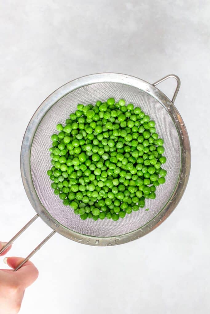 Frozen peas, rinsed in warm water.
