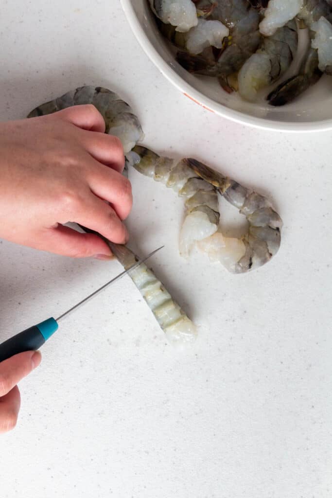 Shrimp being cut.