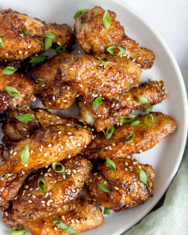 Close up of a plate of Korean air fryer chicken wings.
