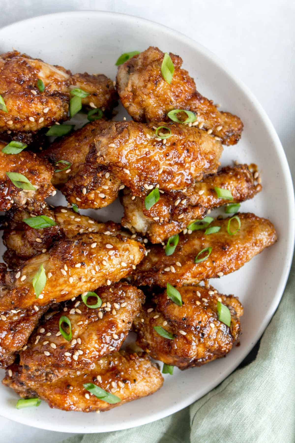 Close up of a plate of Korean air fryer chicken wings.