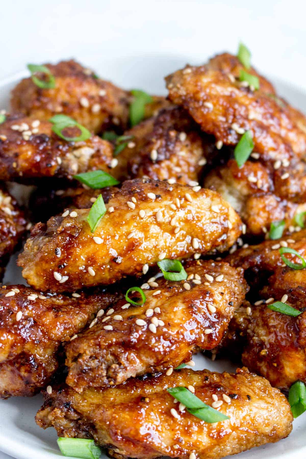 Close up of a plate of Korean air fryer chicken wings.