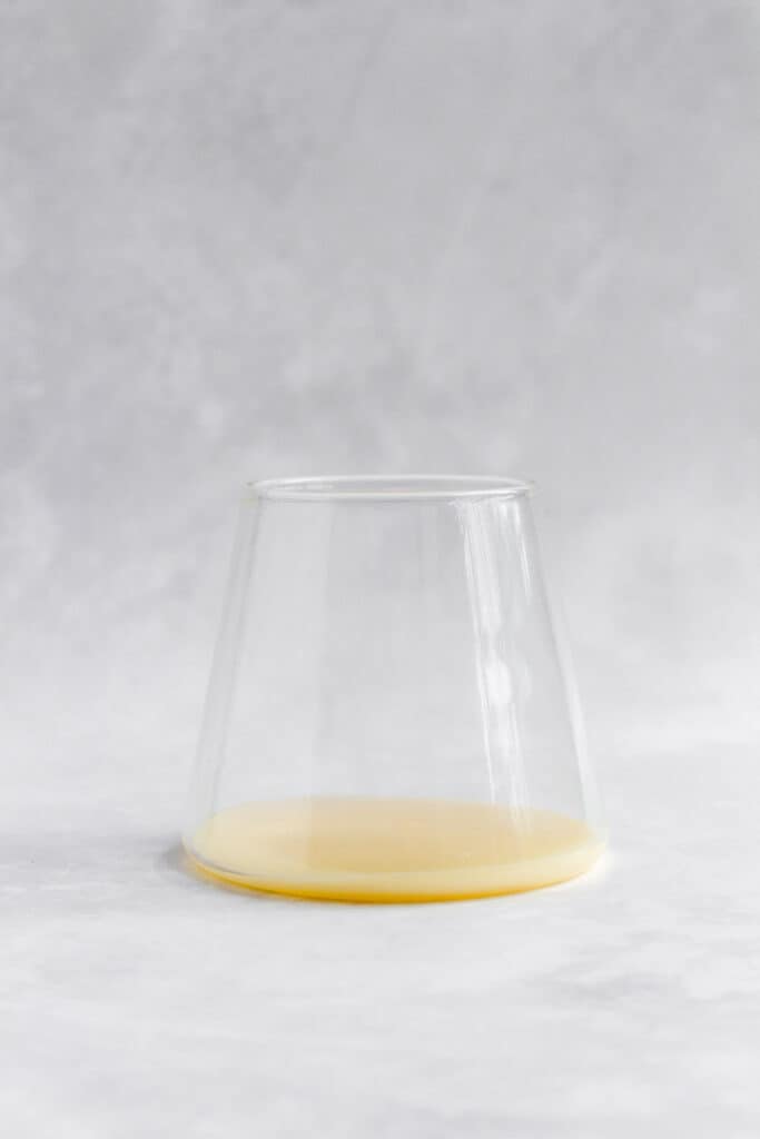 A glass with sweetened condensed milk.