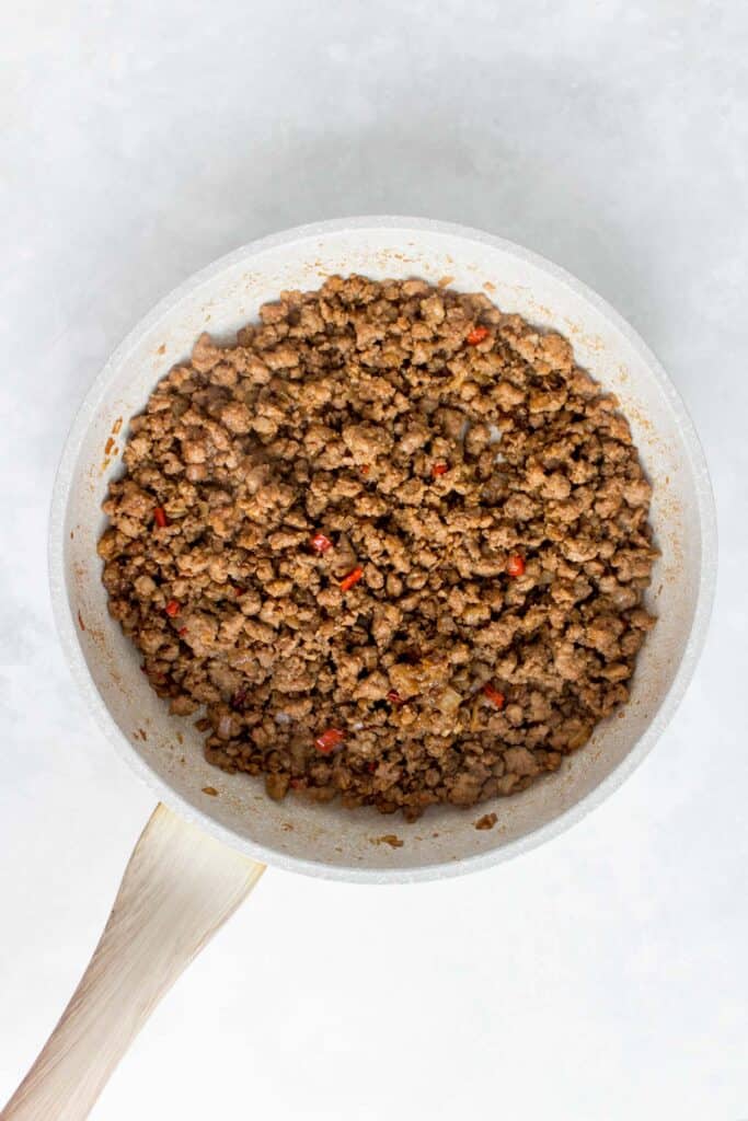 Ground pork cooked in a pan.