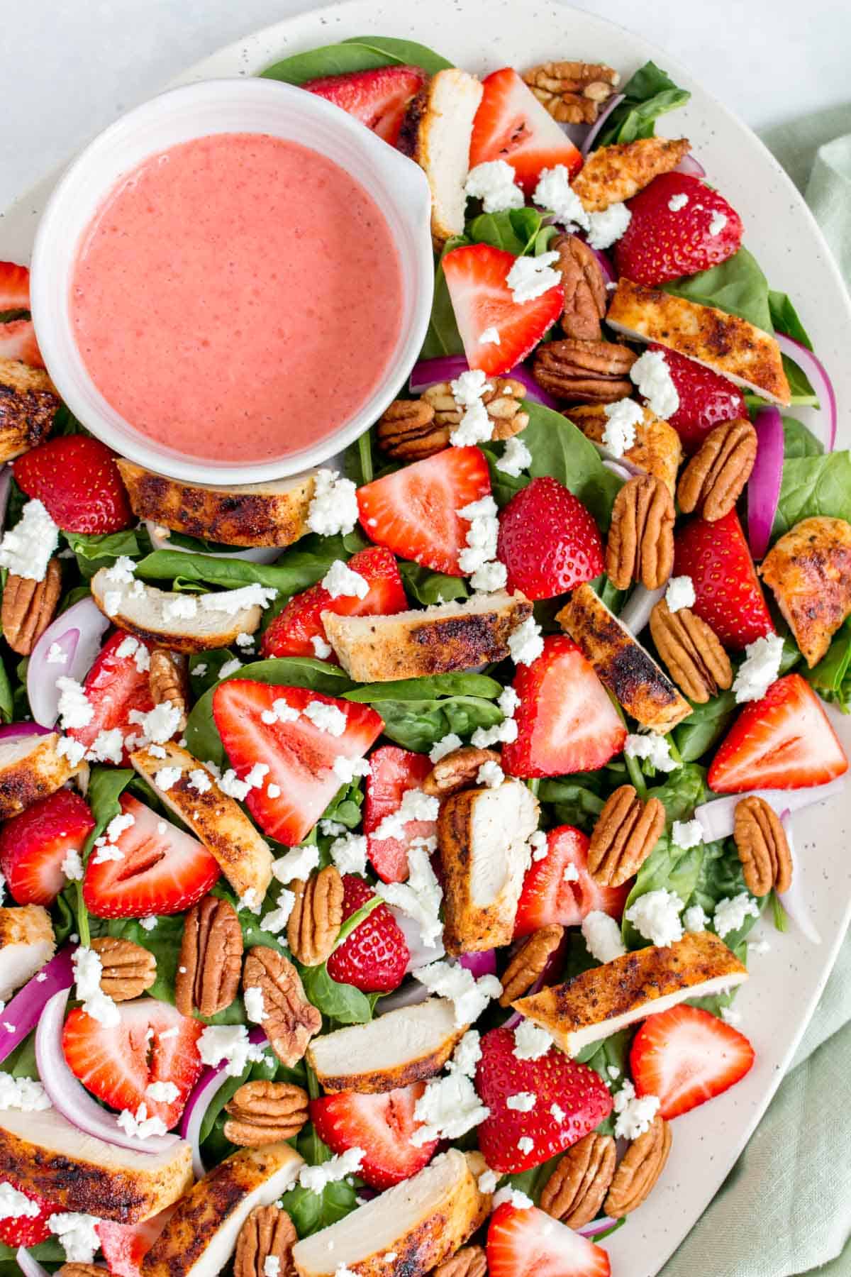 Close up of a strawberry spinach salad.