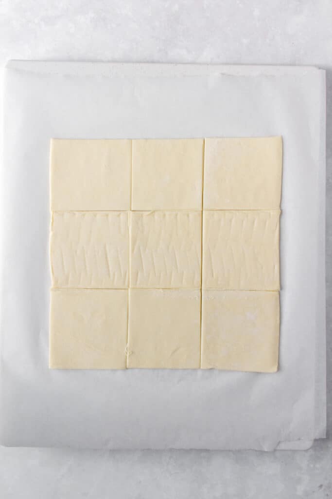 Puff pastry sheet cut into 9 squares.