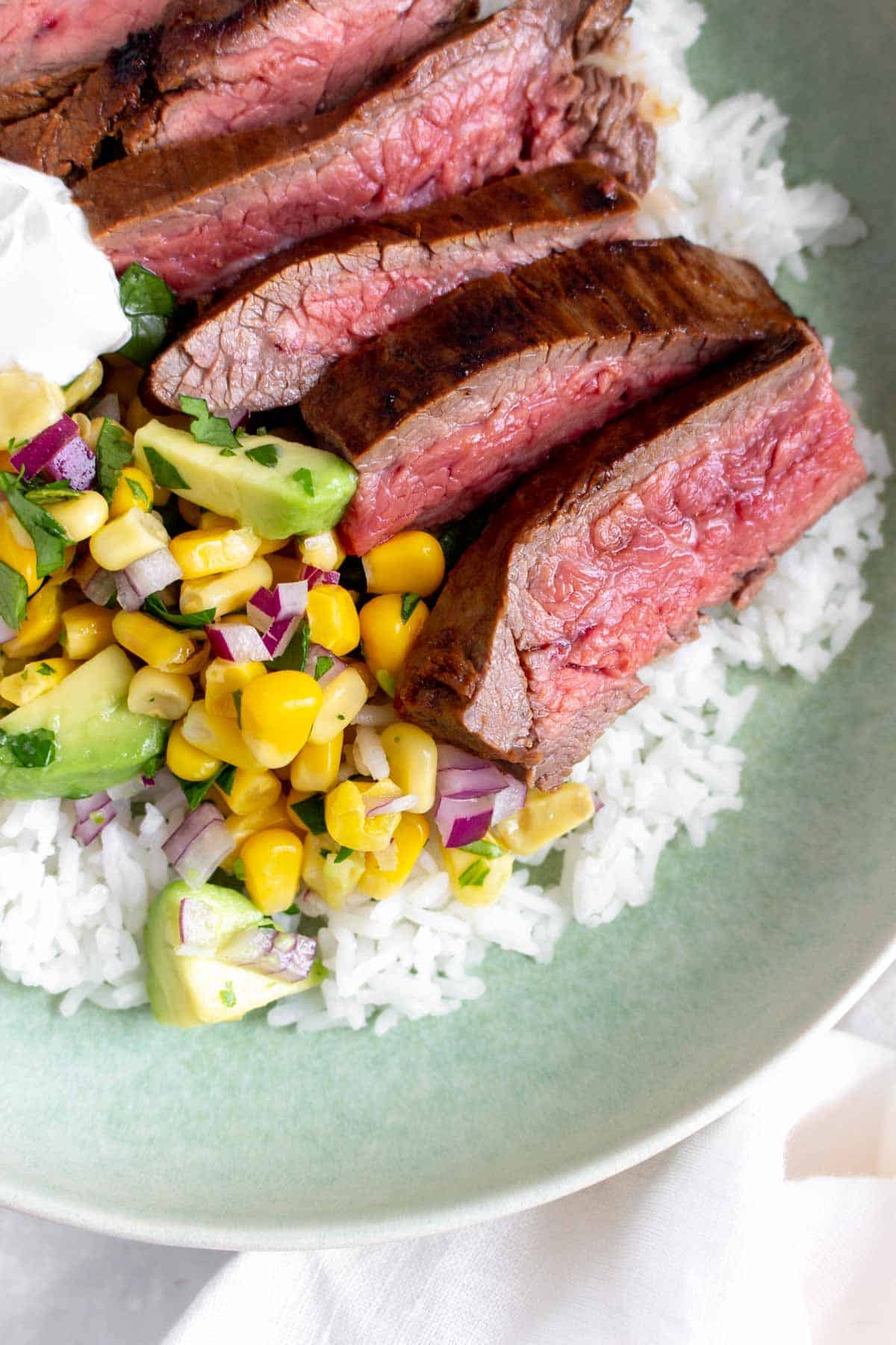 Close up of sliced steak in a bowl.