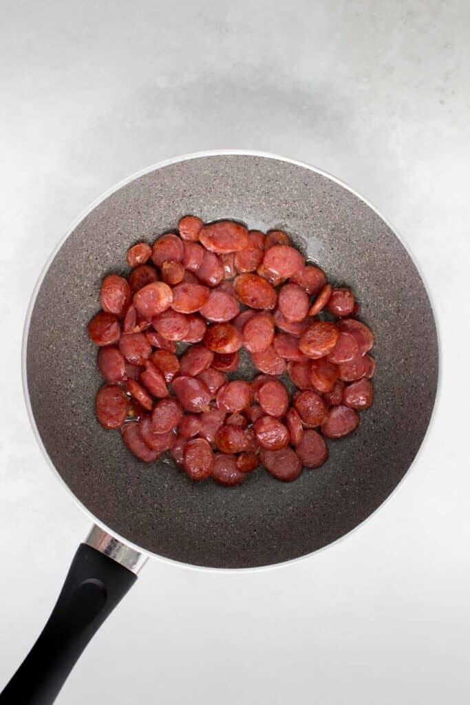 Chinese sausage sautéed in a pan.