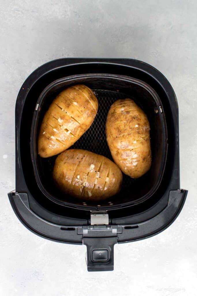 Potatoes added to the air fryer basket.