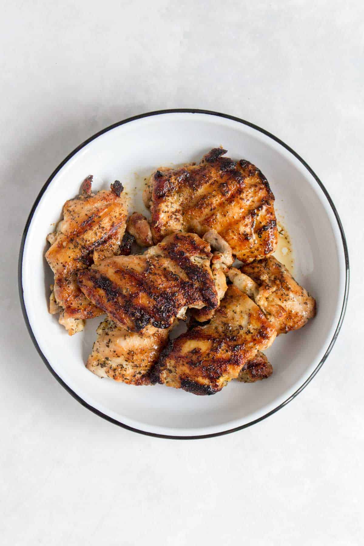 Grilled chicken thighs in a plate.