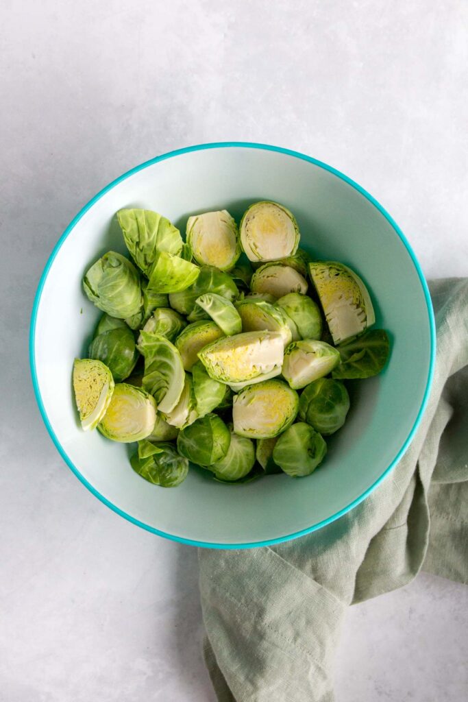 A bowl of cut brussels sprouts.