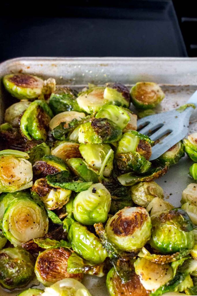 Brussels sprouts being tossed in maple syrup.