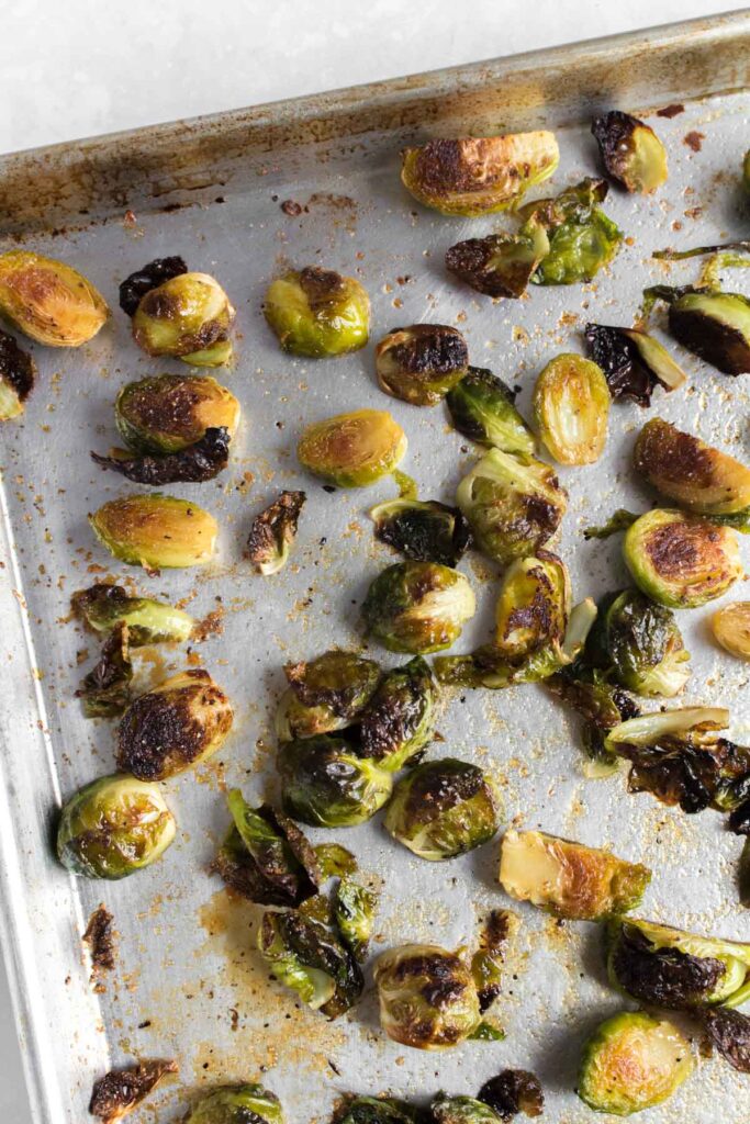A sheet pan of roasted brussels sprouts with maple syrup glaze.