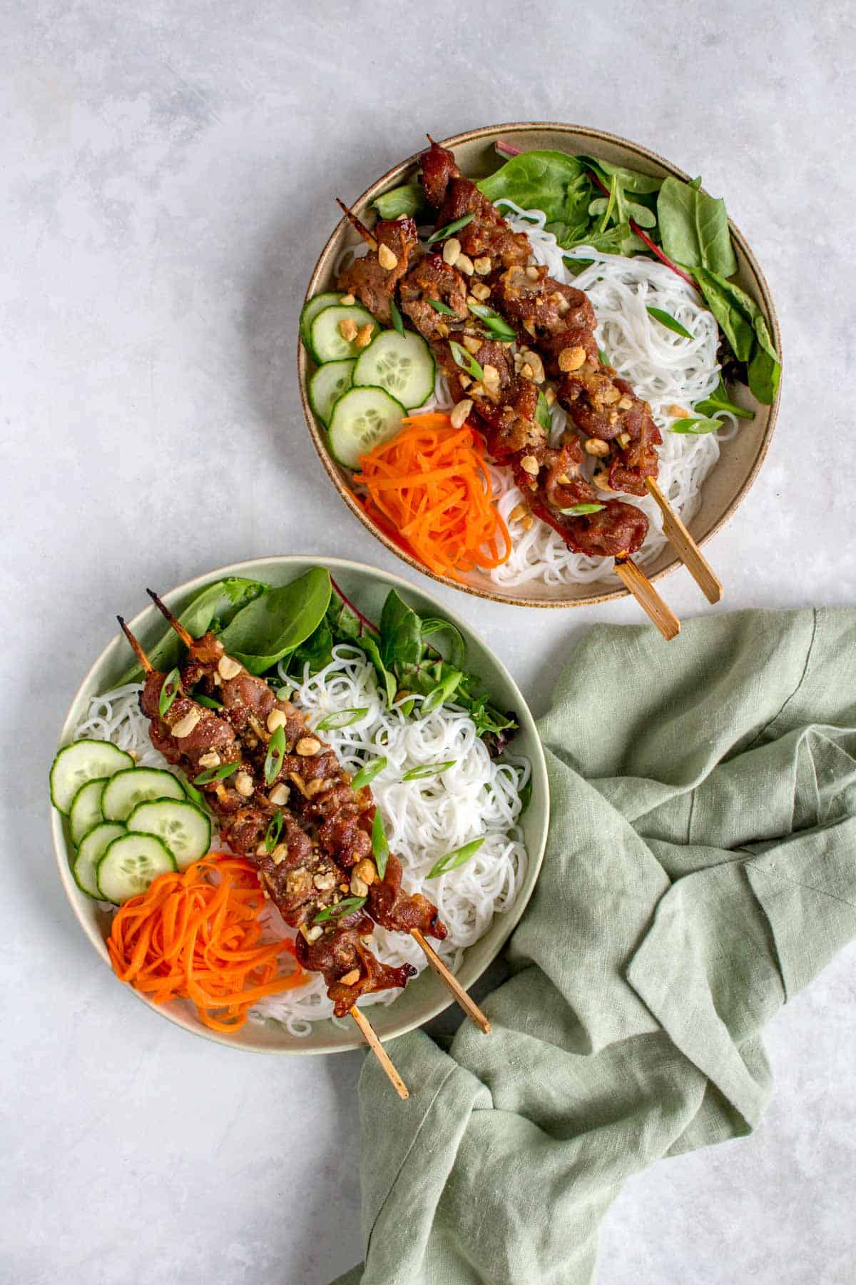Two plates of bun thit nuong (Vietnamese grilled pork with rice-vermicelli noodle).