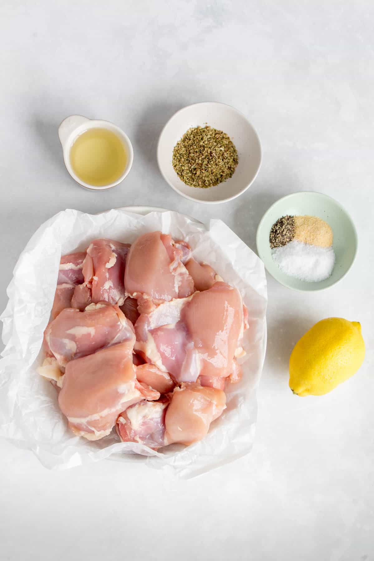 Ingredients needed to make Greek chicken thighs.