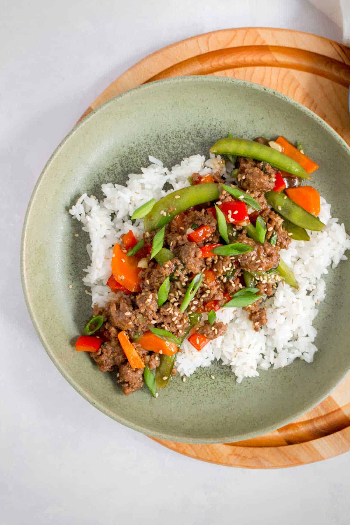 A plate of rice and beef stir fry.