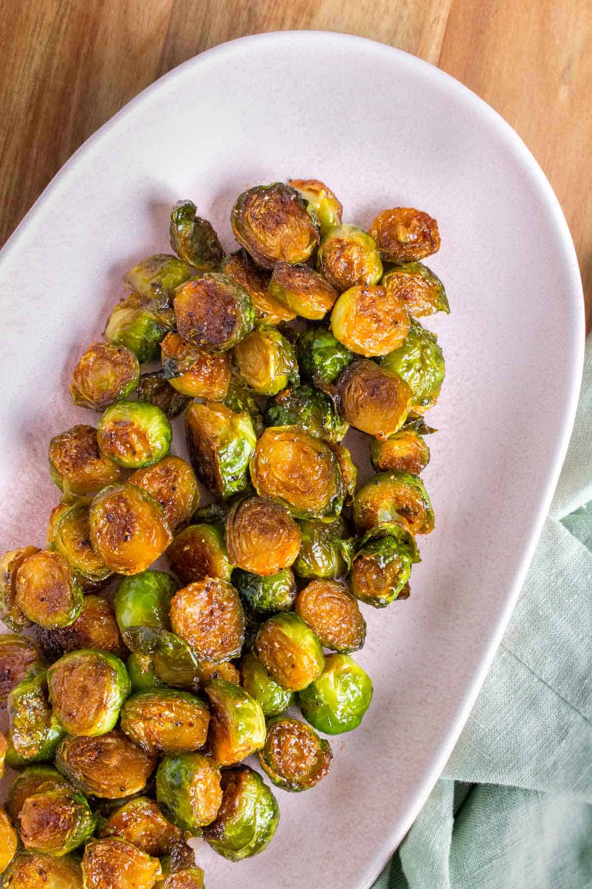 Close up photo of a platter of honey sriracha brussels sprouts.