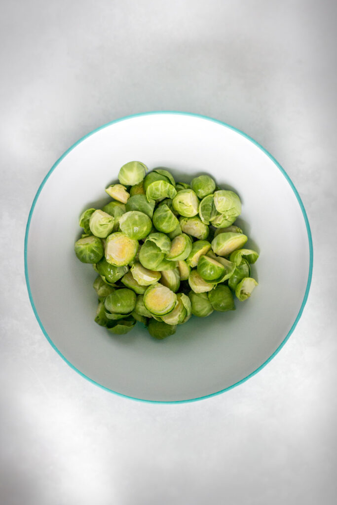 Cut brussels sprouts in a bowl.