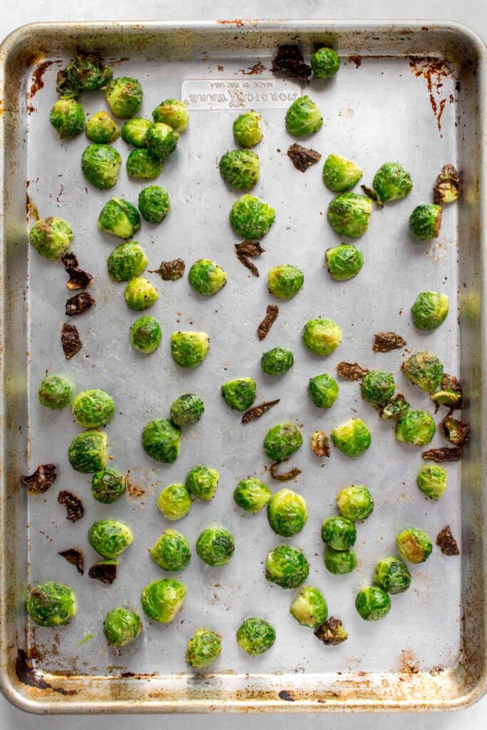 Roasted brussels sprouts on a sheet pan.