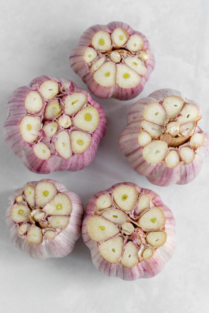 Garlic bulbs with the tops cut off.