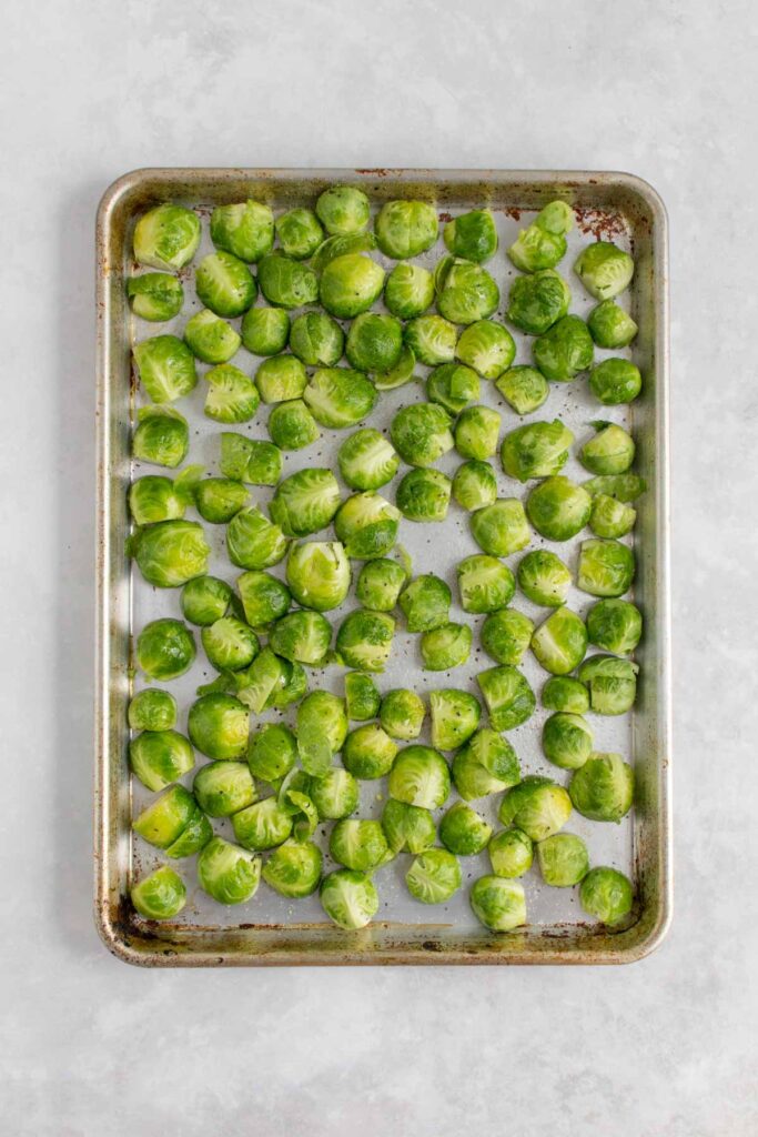 Sheet pan with brussels sprouts, cut side down.