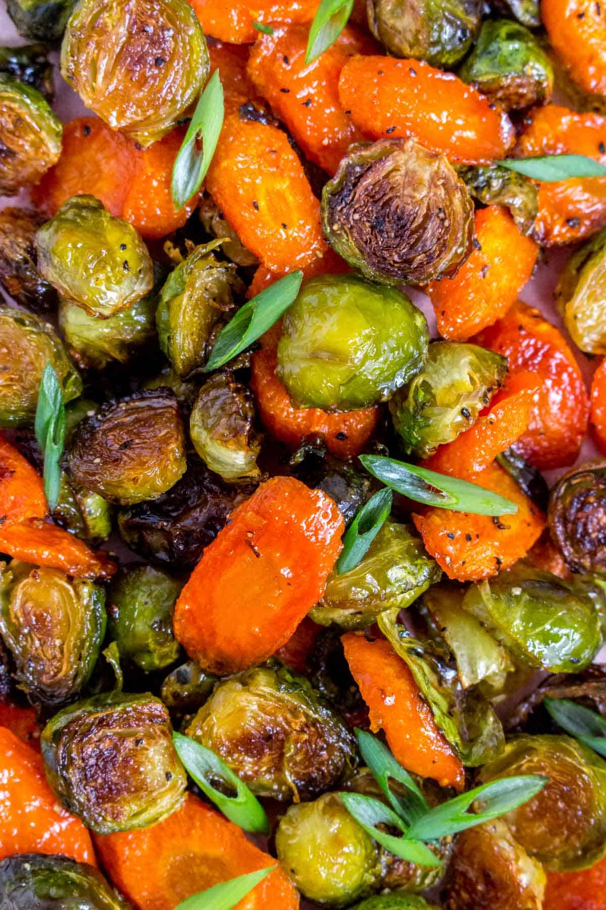 Close up of roasted brussels sprouts and carrots.