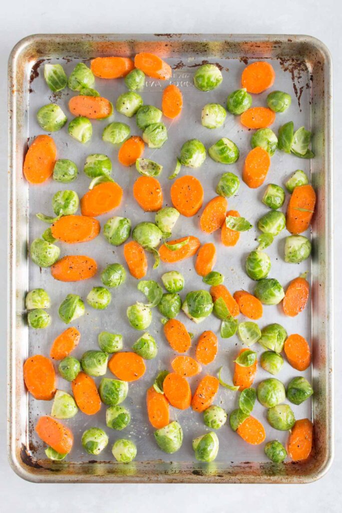 Sheet pan with brussels sprouts and carrots.