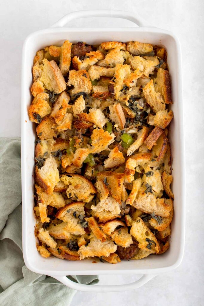 A baking dish with sourdough stuffing with sausage, thyme, sage, and mushrooms.