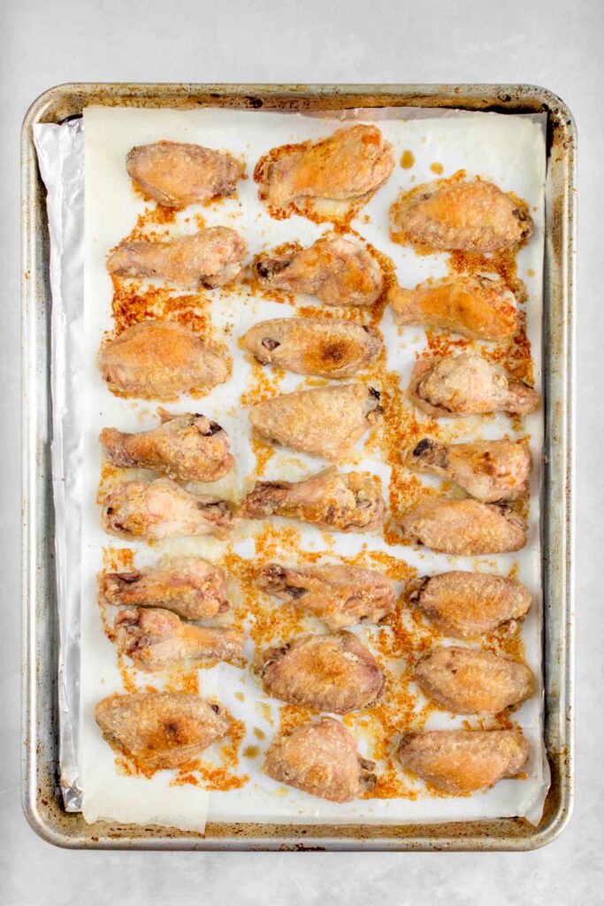Oven baked chicken wings on a sheet pan.