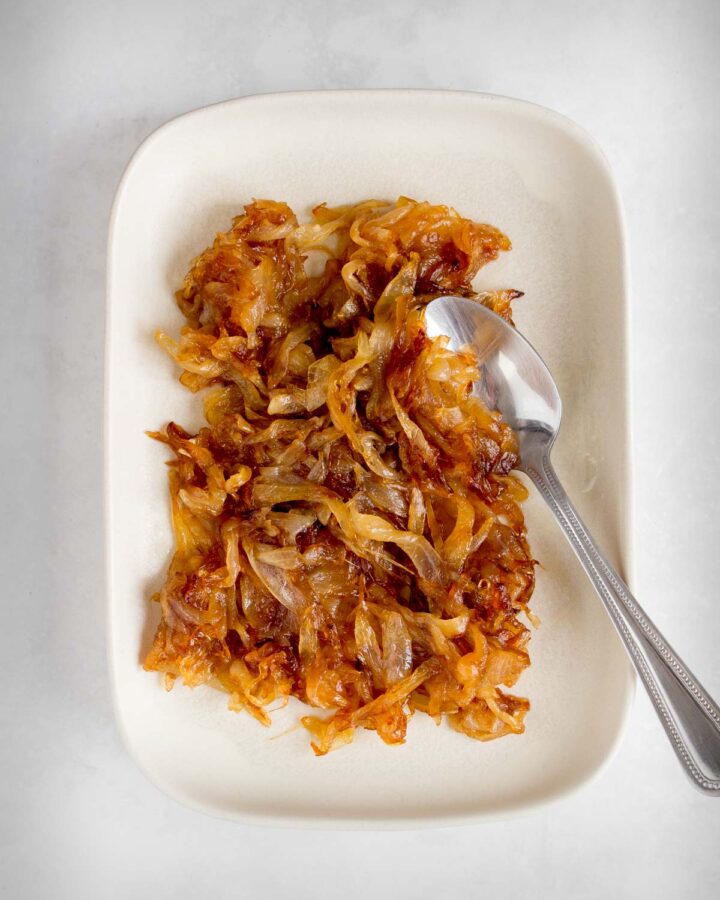 Caramelized onion on a plate with a spoon.