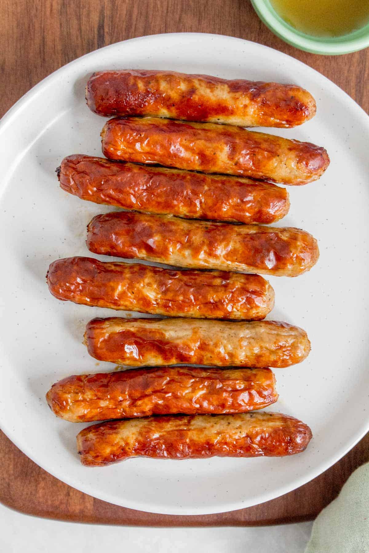 Overhead view of a plate of air fryer breakfast sausages.