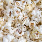 Close up of popcorn with parmesan and black pepper.