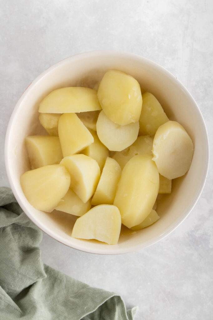 A bowl of cooked potatoes.