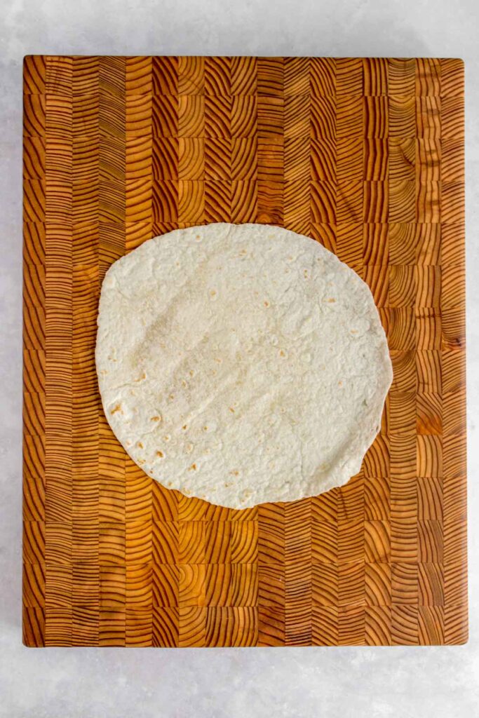 A tortilla wrap on a serving board.