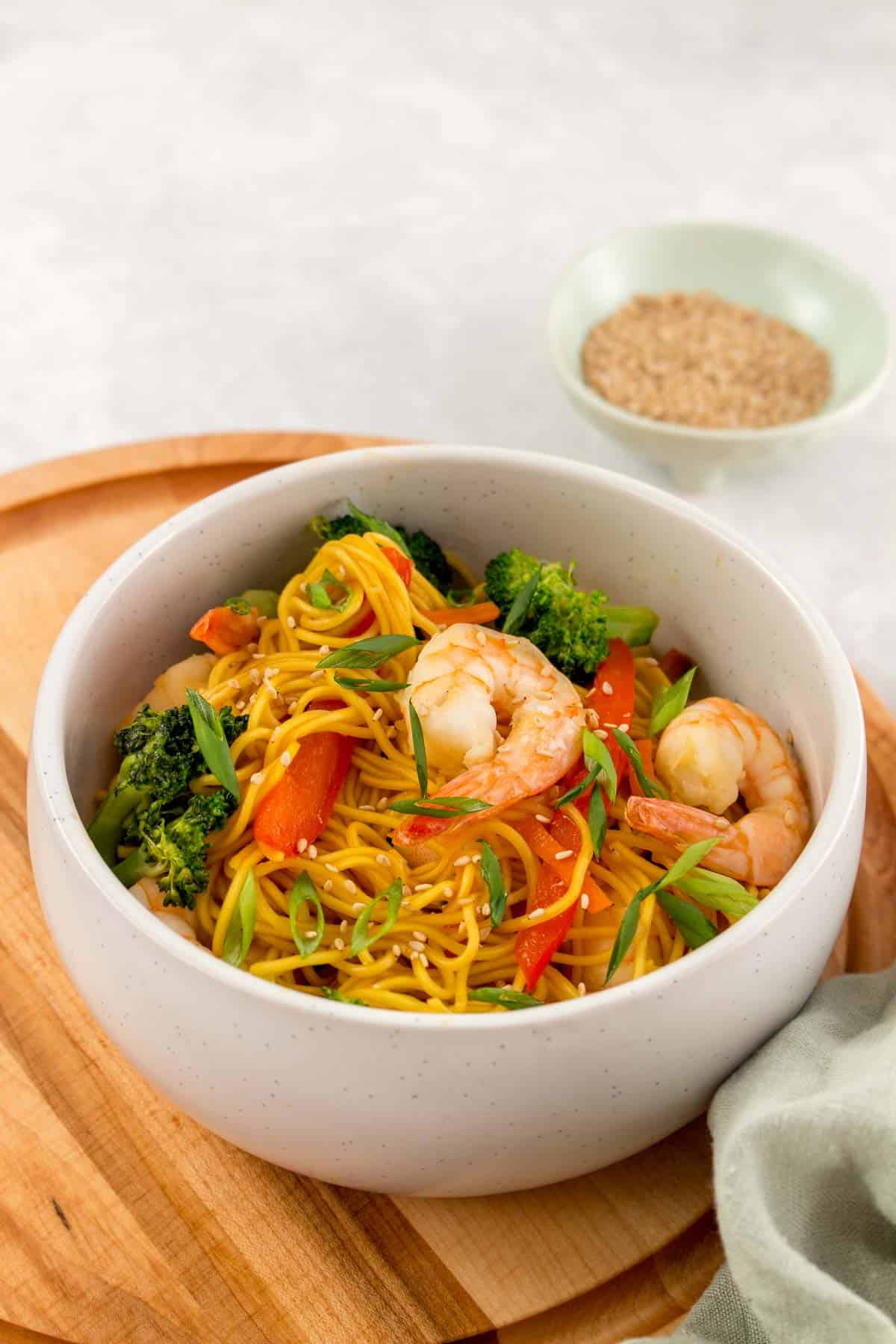 A bowl of shrimp with stir fry noodles.